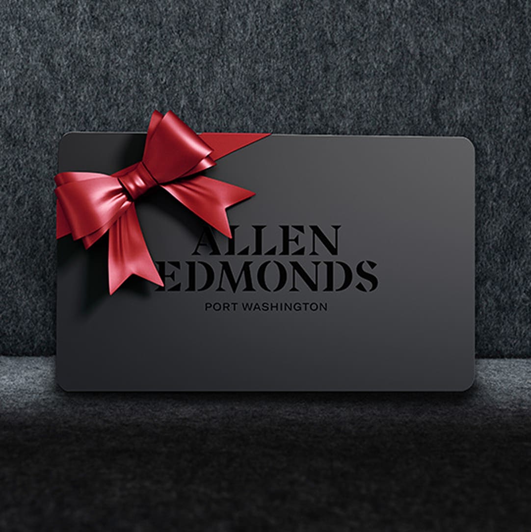 A side view of a brown suede men’s sneaker with the toe facing left.