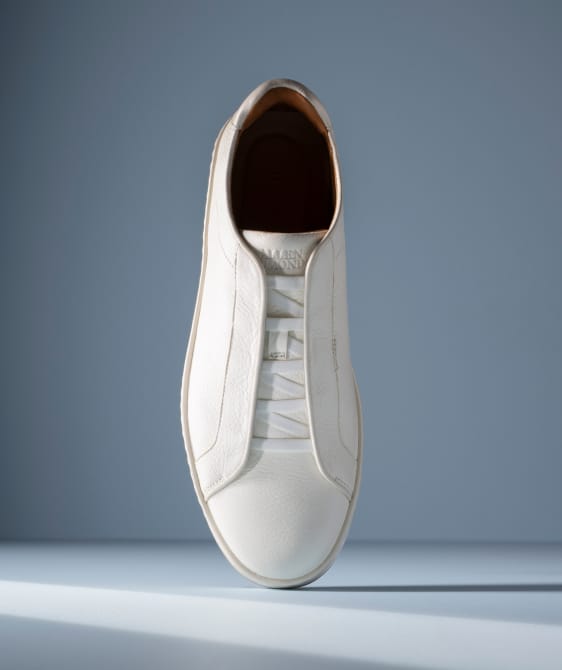 Men’s gray textured leather sneaker with tan rubber sole and brown leather lining